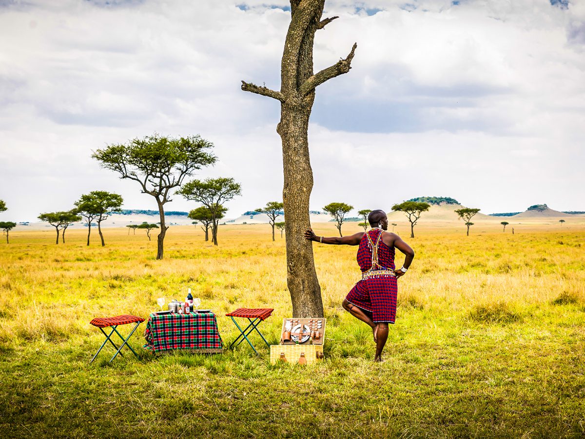 Safari vehicle crossing open grassland in Kenya